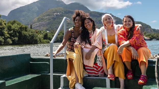 A group of women sitting on a boat Description automatically generated