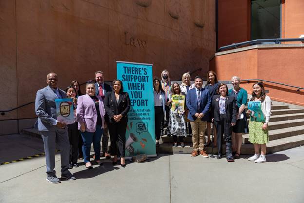 A group of people standing in front of a building  Description automatically generated