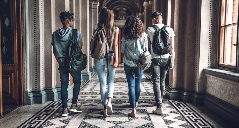 A group of people walking in a hallway Description automatically generated