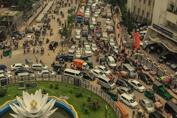 Traffic in the capital, Dhaka, wends its way past Shapla Square, which showcases a sculpture of a water-lily (or shapla), Bangladesh&rsquo;s national flower.  