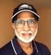 A person wearing a hat and glasses Description automatically generated
