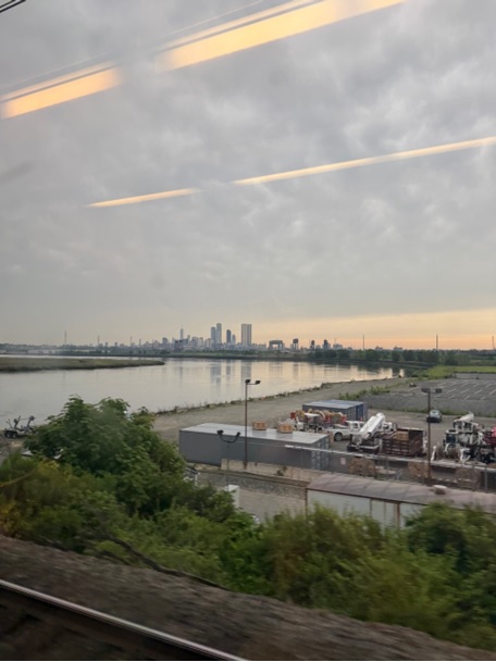 A city skyline seen from a window  AI-generated content may be incorrect.