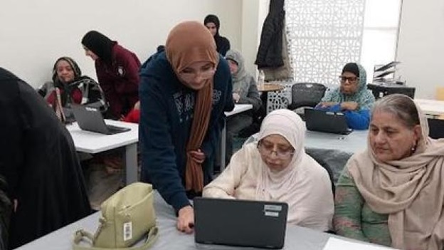 A person looking at a computer  AI-generated content may be incorrect.