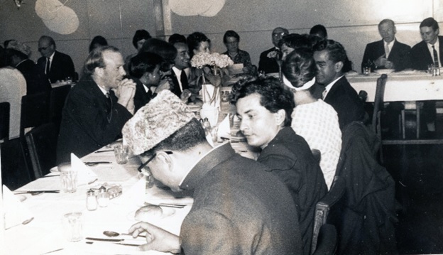 A group of people sitting at a table  AI-generated content may be incorrect.