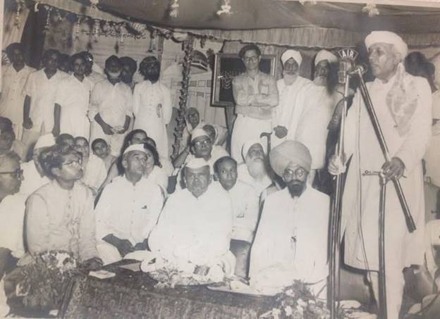 A group of men standing in front of a person standing in front of a person  AI-generated content may be incorrect.