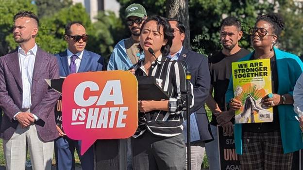 A person speaking at a podium  AI-generated content may be incorrect.