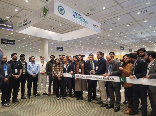 A group of people standing in a room with a ribbon  AI-generated content may be incorrect.